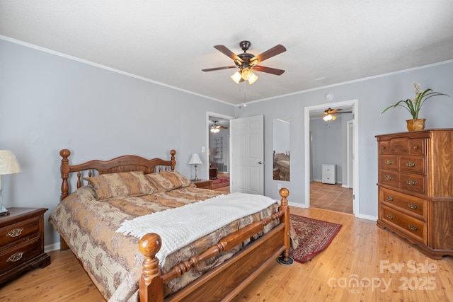 bedroom with crown molding, light wood-style flooring, baseboards, and ceiling fan