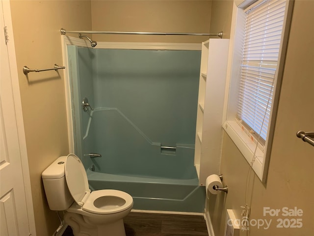 bathroom featuring shower / bath combination, toilet, and wood finished floors