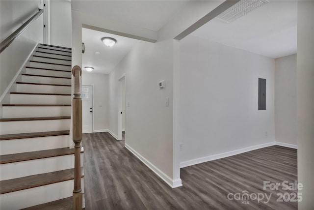 stairs with baseboards, visible vents, and wood finished floors