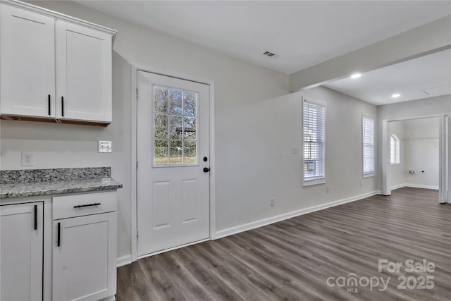 doorway to outside featuring visible vents, baseboards, dark wood finished floors, and recessed lighting