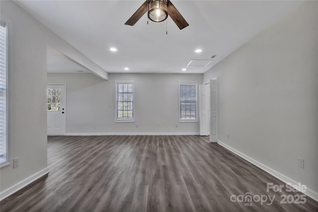 unfurnished living room featuring attic access, recessed lighting, dark wood-style flooring, and baseboards