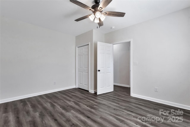 unfurnished bedroom with dark wood finished floors, baseboards, and ceiling fan