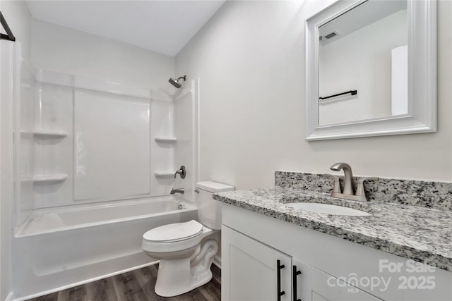 full bathroom with shower / tub combination, toilet, wood finished floors, visible vents, and vanity