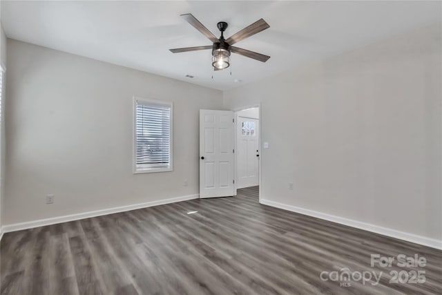 unfurnished room featuring ceiling fan, dark wood-type flooring, visible vents, and baseboards