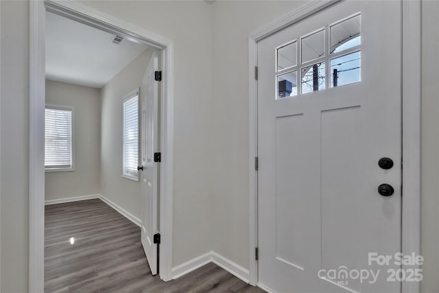 entryway featuring dark wood-type flooring, visible vents, and baseboards