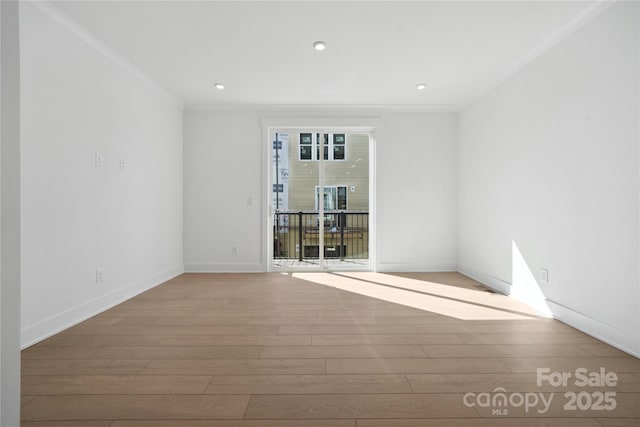 spare room featuring ornamental molding, recessed lighting, wood finished floors, and baseboards