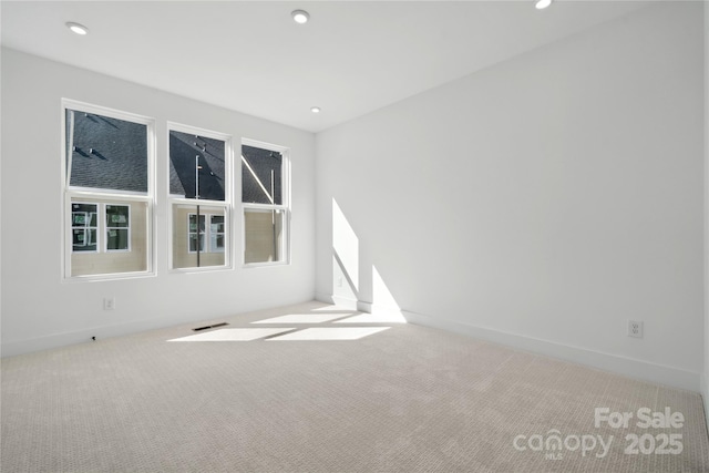 spare room with baseboards, carpet, and recessed lighting