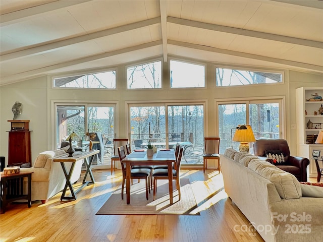 sunroom / solarium featuring vaulted ceiling with beams and a wealth of natural light