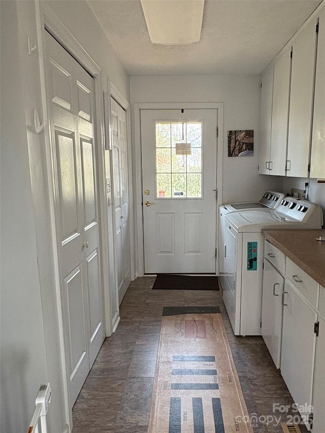 laundry area featuring cabinet space, dark wood-style flooring, and washing machine and clothes dryer