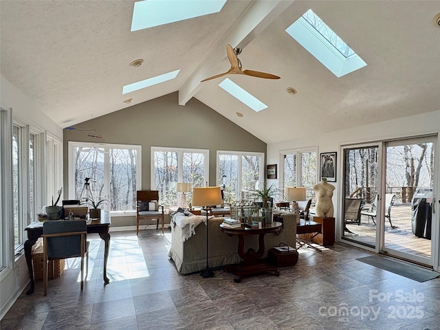 living area with a textured ceiling, high vaulted ceiling, plenty of natural light, and beam ceiling