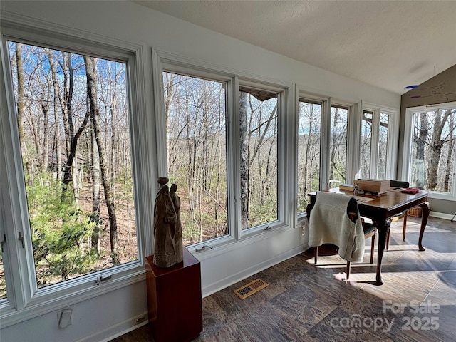 sunroom / solarium featuring lofted ceiling and visible vents