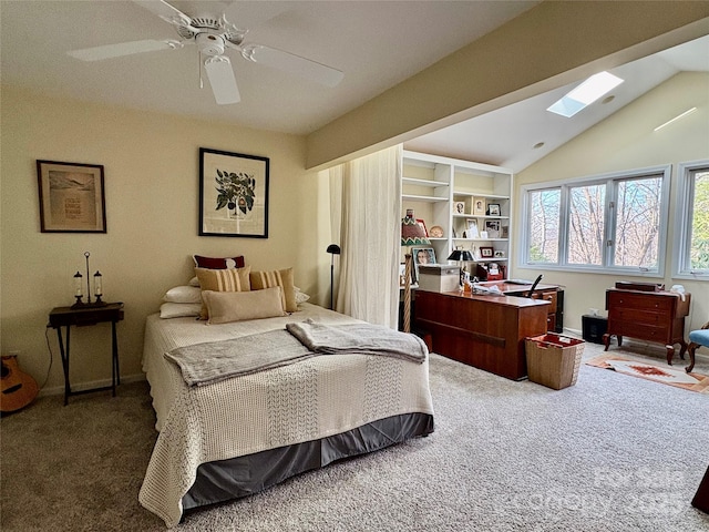 bedroom with vaulted ceiling with skylight, carpet flooring, ceiling fan, and baseboards