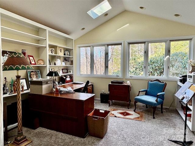 office with lofted ceiling with skylight and carpet floors