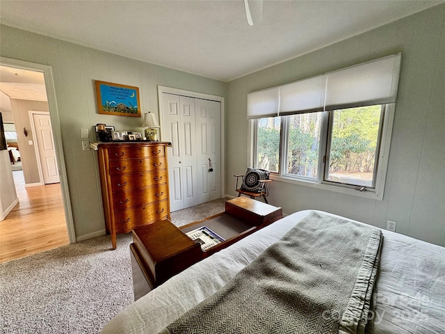 bedroom with a closet and light carpet