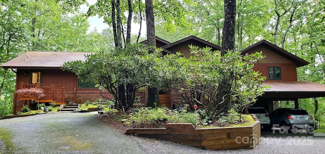 view of front of home with a carport, driveway, and brick siding