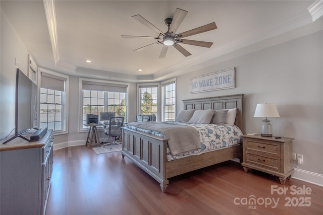 bedroom with a raised ceiling, crown molding, baseboards, and dark wood-style flooring