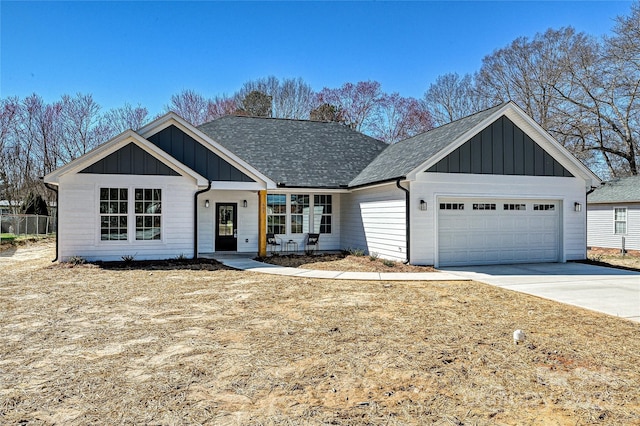 view of front facade featuring board and batten siding, concrete driveway, roof with shingles, and an attached garage