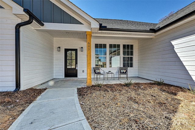 entrance to property featuring a porch, board and batten siding, and a shingled roof