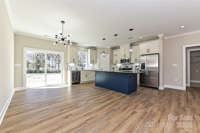 kitchen featuring wood finished floors, baseboards, appliances with stainless steel finishes, tasteful backsplash, and crown molding