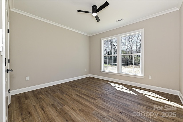 unfurnished room featuring ornamental molding, dark wood-style flooring, and visible vents