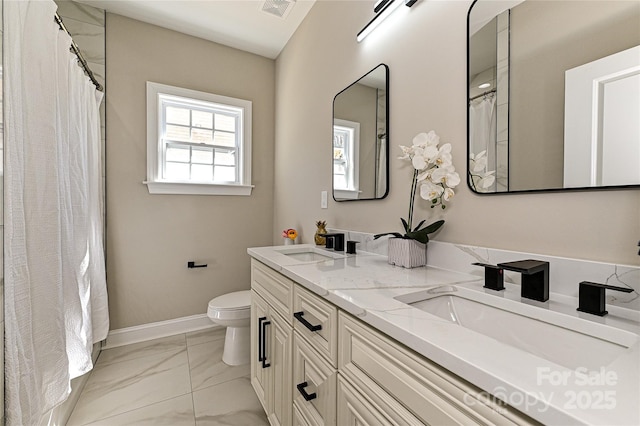 full bath featuring toilet, marble finish floor, a sink, and visible vents