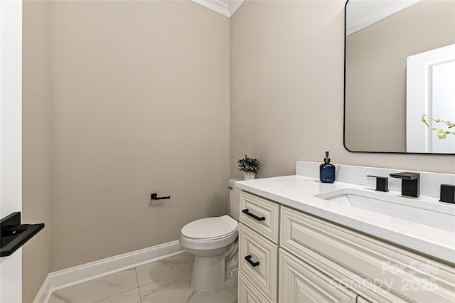 half bathroom featuring vanity, toilet, and baseboards