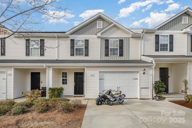 multi unit property with a garage and concrete driveway