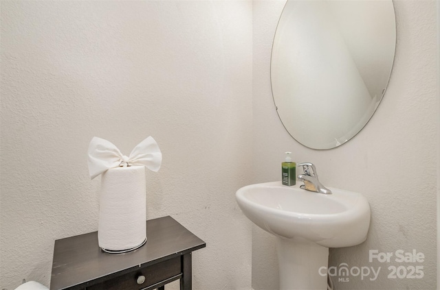 bathroom with a textured wall