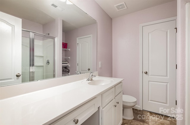 full bath with visible vents, a shower stall, toilet, and vanity