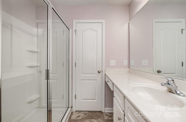 bathroom with a stall shower and vanity