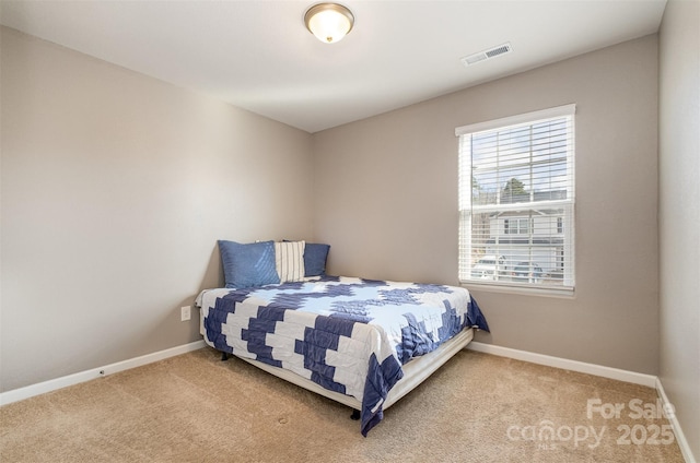 carpeted bedroom featuring visible vents and baseboards