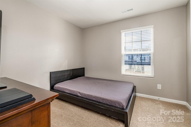 bedroom with light colored carpet, visible vents, and baseboards