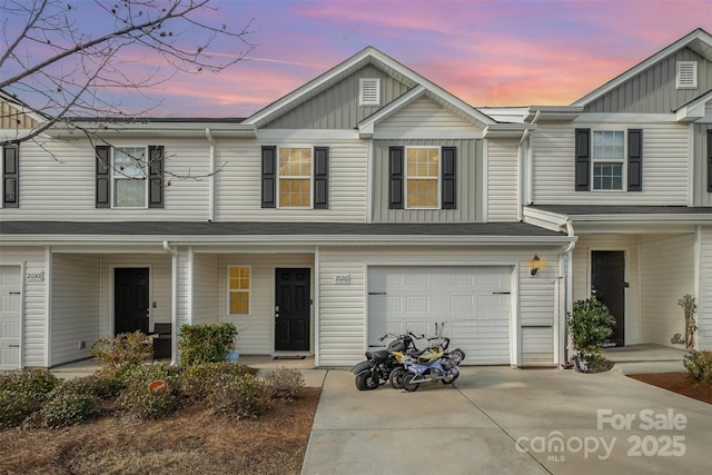 townhome / multi-family property with a garage, a porch, and concrete driveway