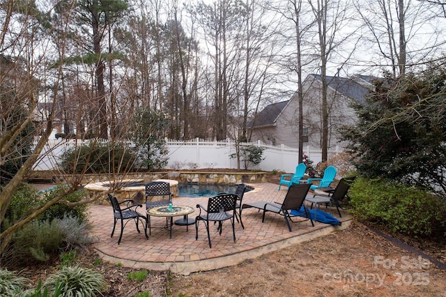 view of patio with a fenced backyard and a fire pit