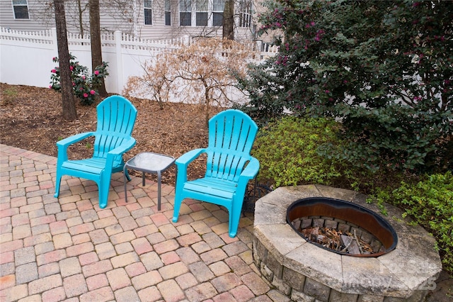 view of patio / terrace featuring an outdoor fire pit and fence