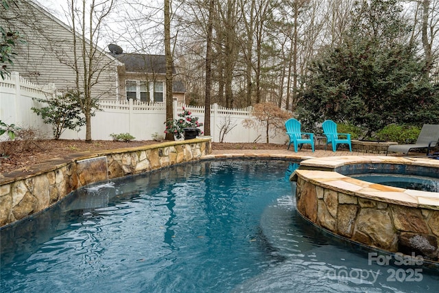 view of swimming pool with a patio area, a fenced backyard, and a pool with connected hot tub