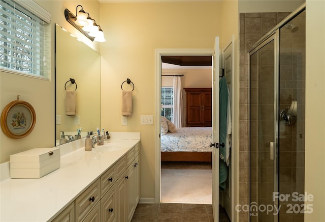 ensuite bathroom featuring tile patterned floors, vanity, connected bathroom, and tiled shower