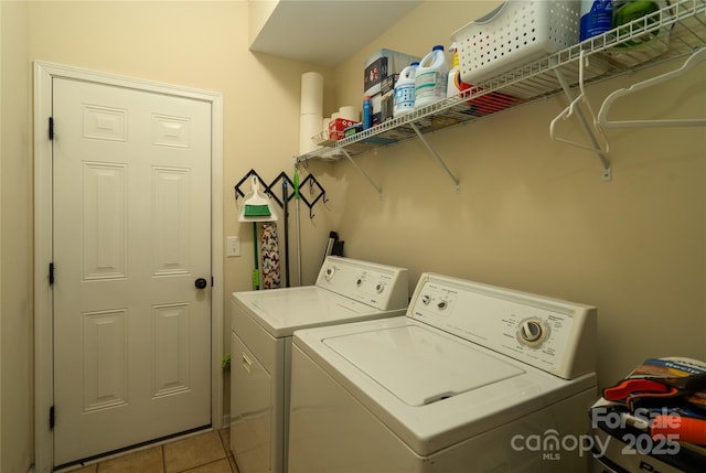 washroom with laundry area, washer and clothes dryer, and tile patterned floors