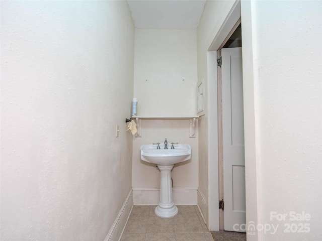 bathroom featuring tile patterned flooring and baseboards