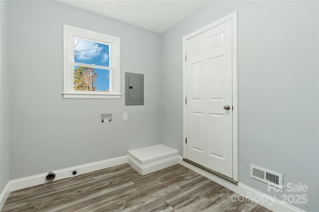 washroom featuring laundry area, wood finished floors, visible vents, and baseboards