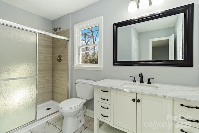 bathroom with a stall shower, marble finish floor, vanity, and toilet