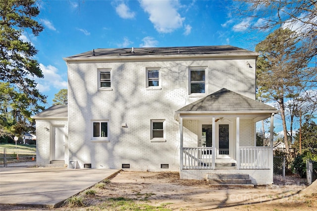 view of front facade with a porch, crawl space, and brick siding