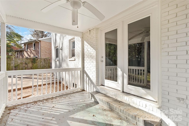 deck with ceiling fan and fence