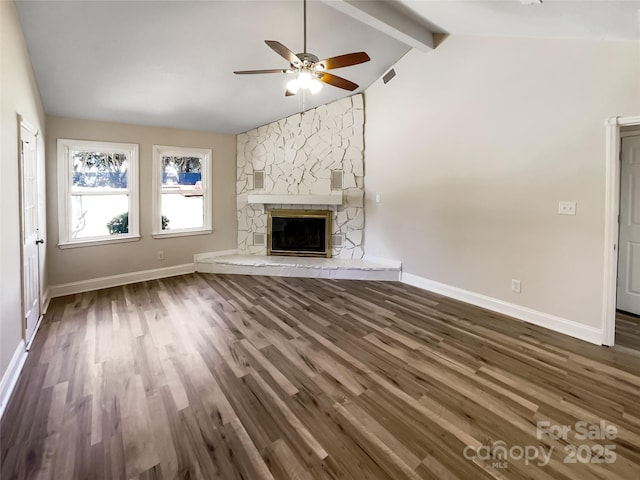 unfurnished living room with baseboards, lofted ceiling with beams, dark wood-style floors, ceiling fan, and a fireplace