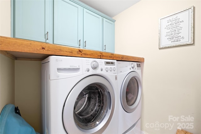 laundry room with cabinet space and washer and clothes dryer