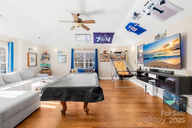 interior space with pool table, baseboards, vaulted ceiling, wood finished floors, and a ceiling fan