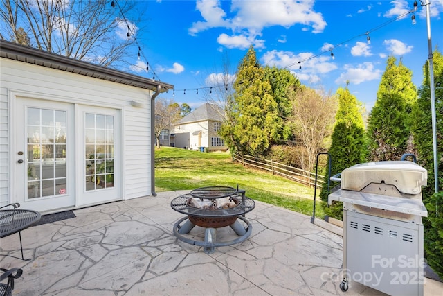 view of patio / terrace with a fire pit, fence, and a grill