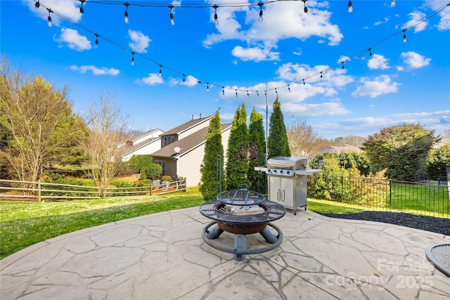 view of patio / terrace featuring a grill, a fire pit, and fence