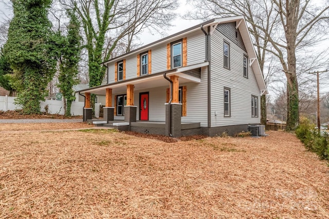 view of front of house with central AC unit, a porch, and fence