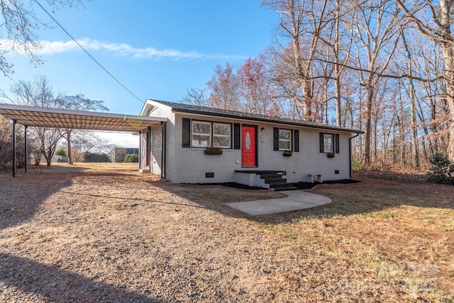 single story home featuring a carport, crawl space, a front lawn, and brick siding